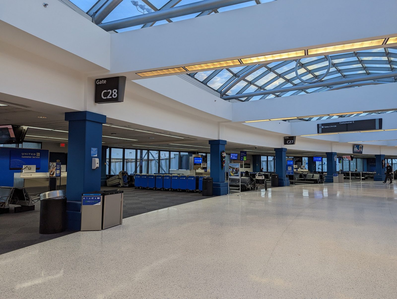 Interior photograph of gate C28 in Concourse C showing the gate desk, flight information display, and waiting area