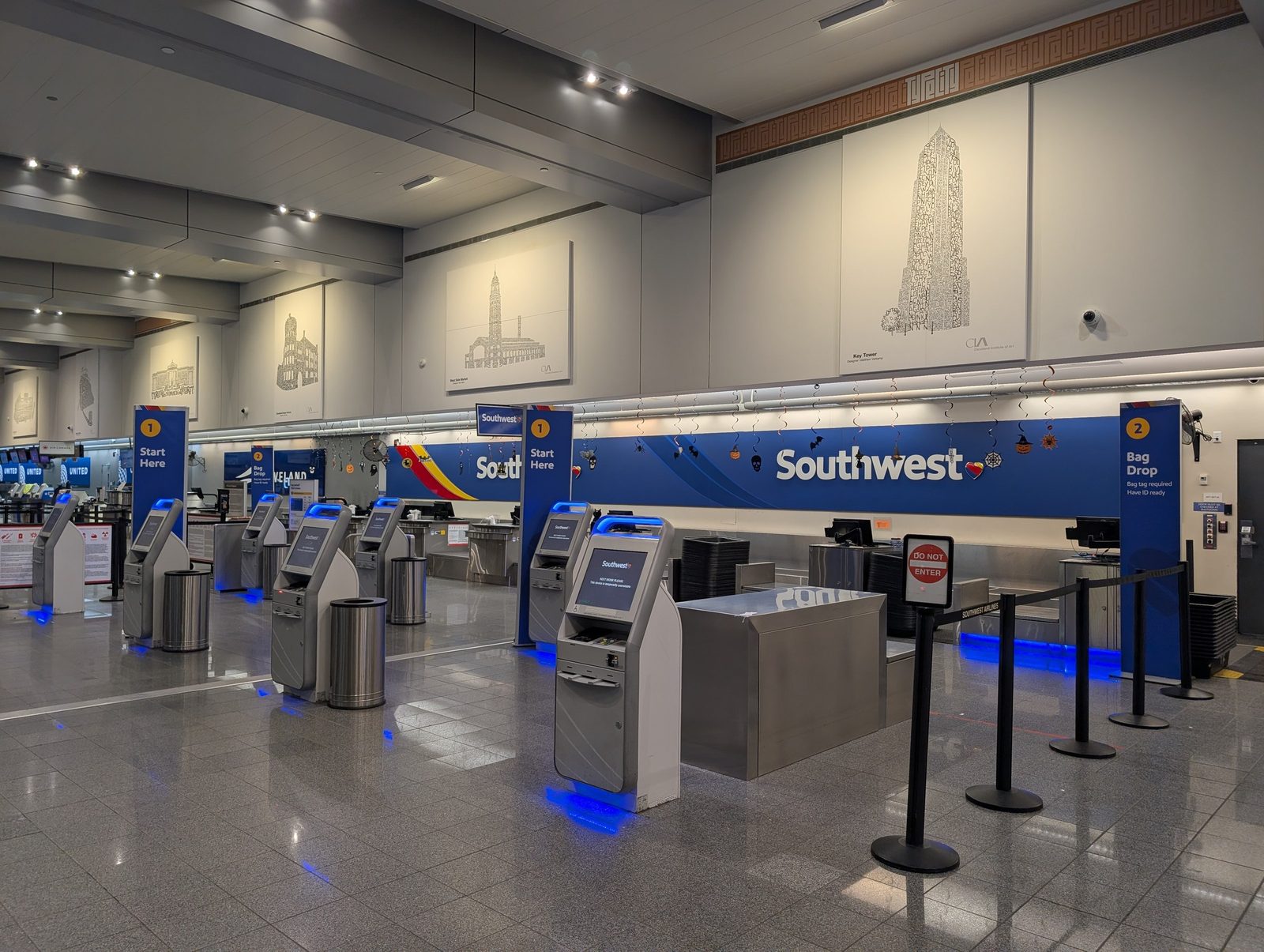 Interior photograph of the Main Terminal check-in hall at the Southwest counters in October 2025, with kiosks, queue lanes, and overhead signage